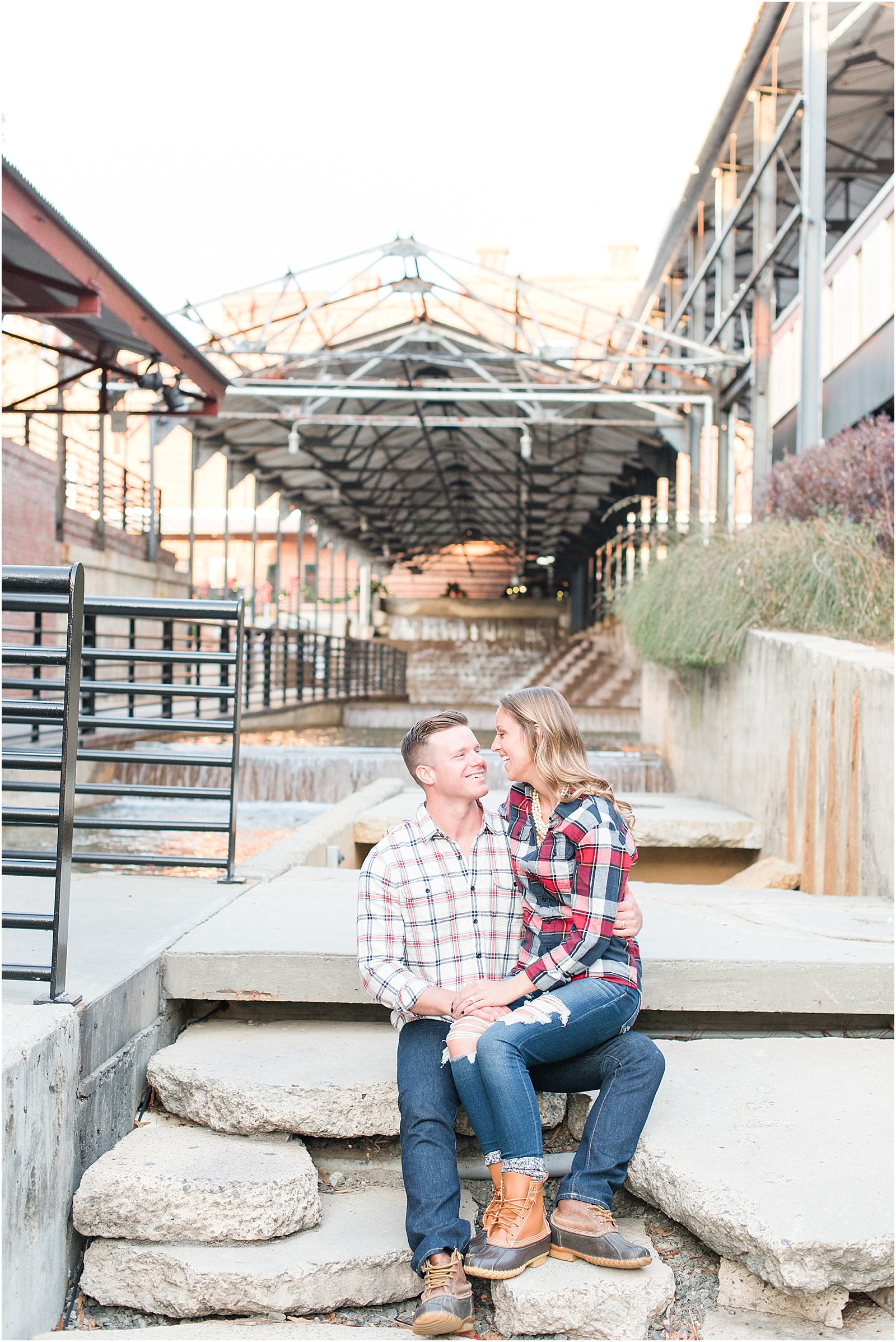 Michelle & Sara Photography, American Tabacco factory, American Tabacco Factory Portrait Session, Michelle & Sara Photography Portrait Session, rugged industrial chic photograph of couple sitting with LL Bean Boots