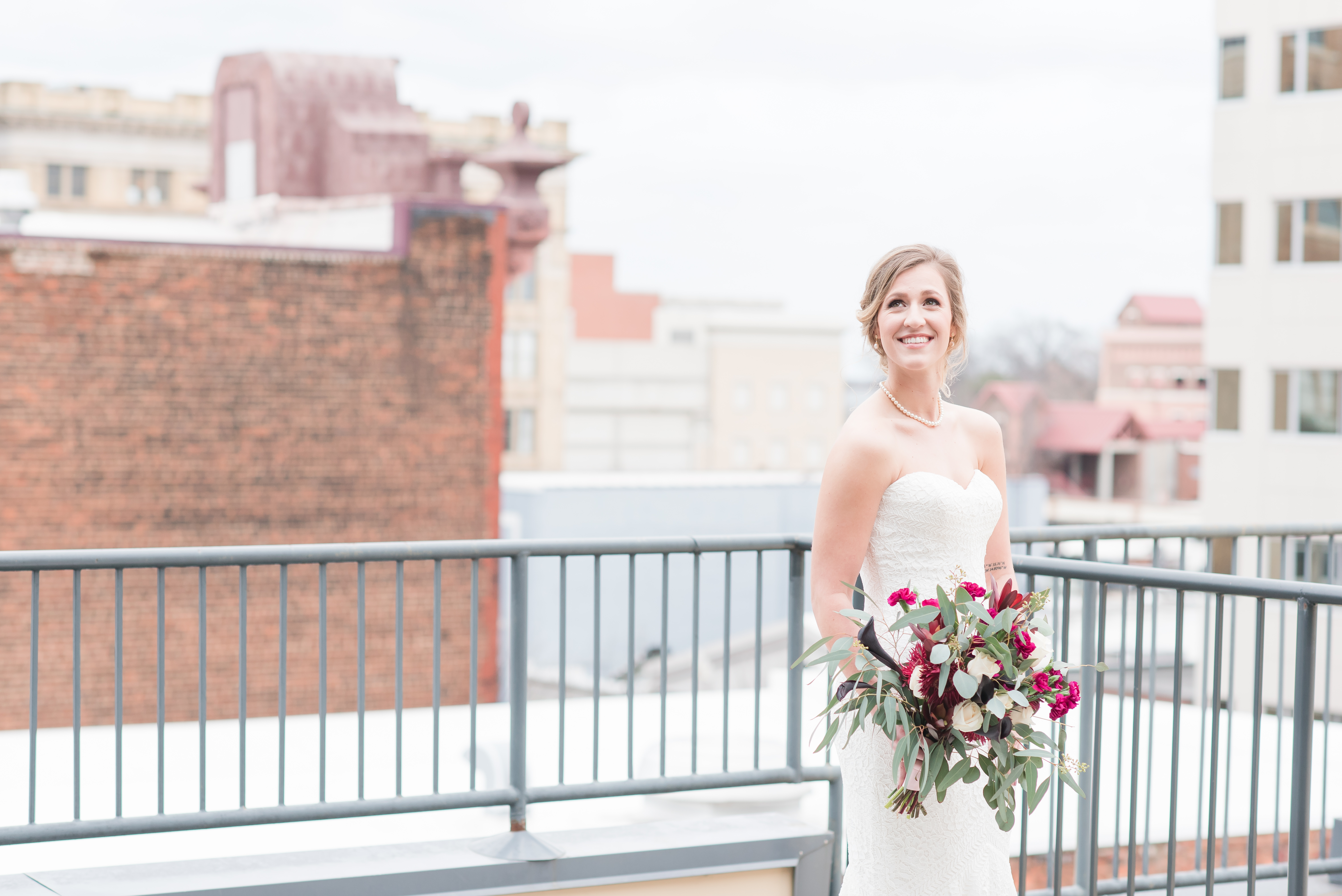 bridal portrait outside of the Glass Box venue overlooking Raleigh