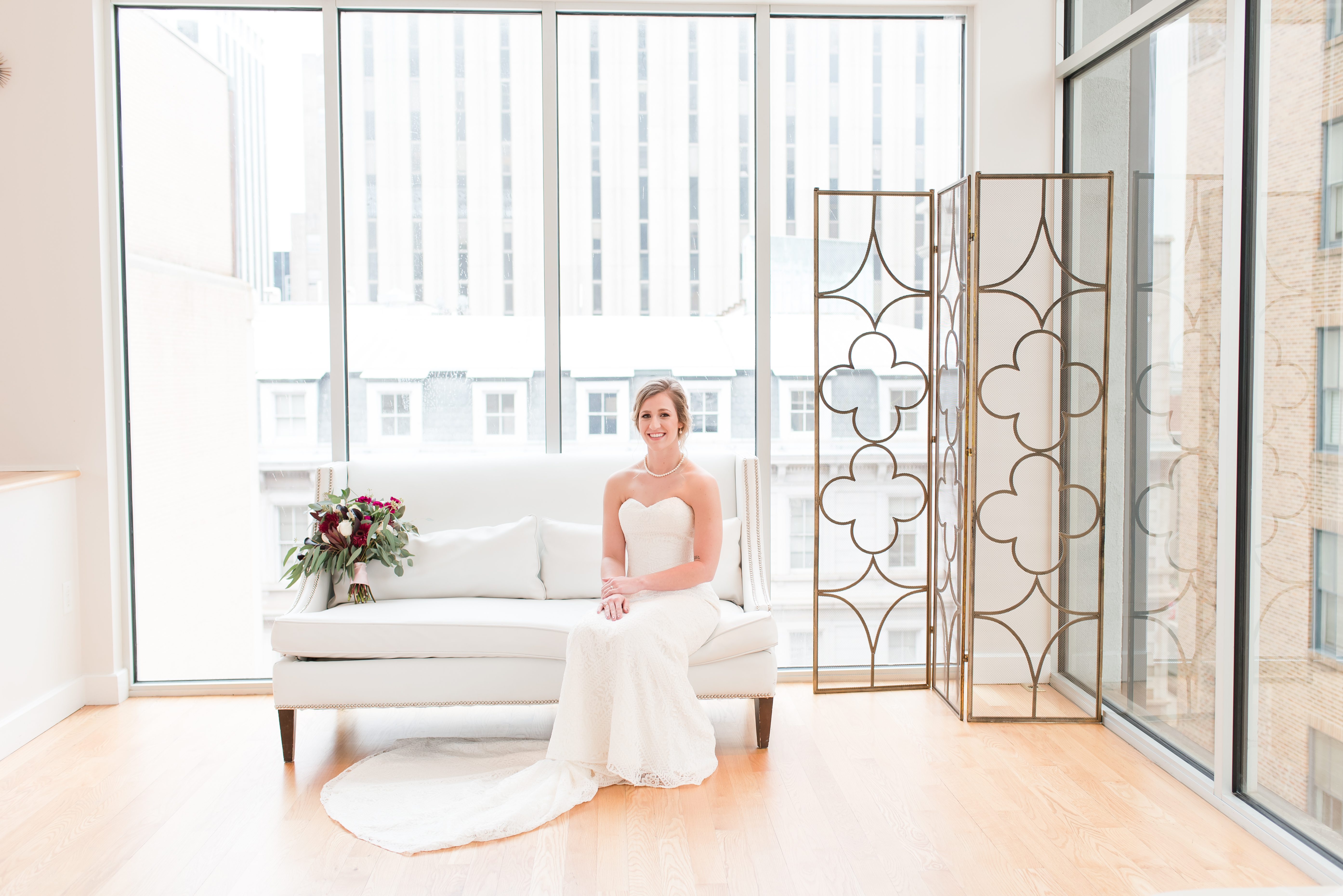 Bride sitting on couch at the Glass Box