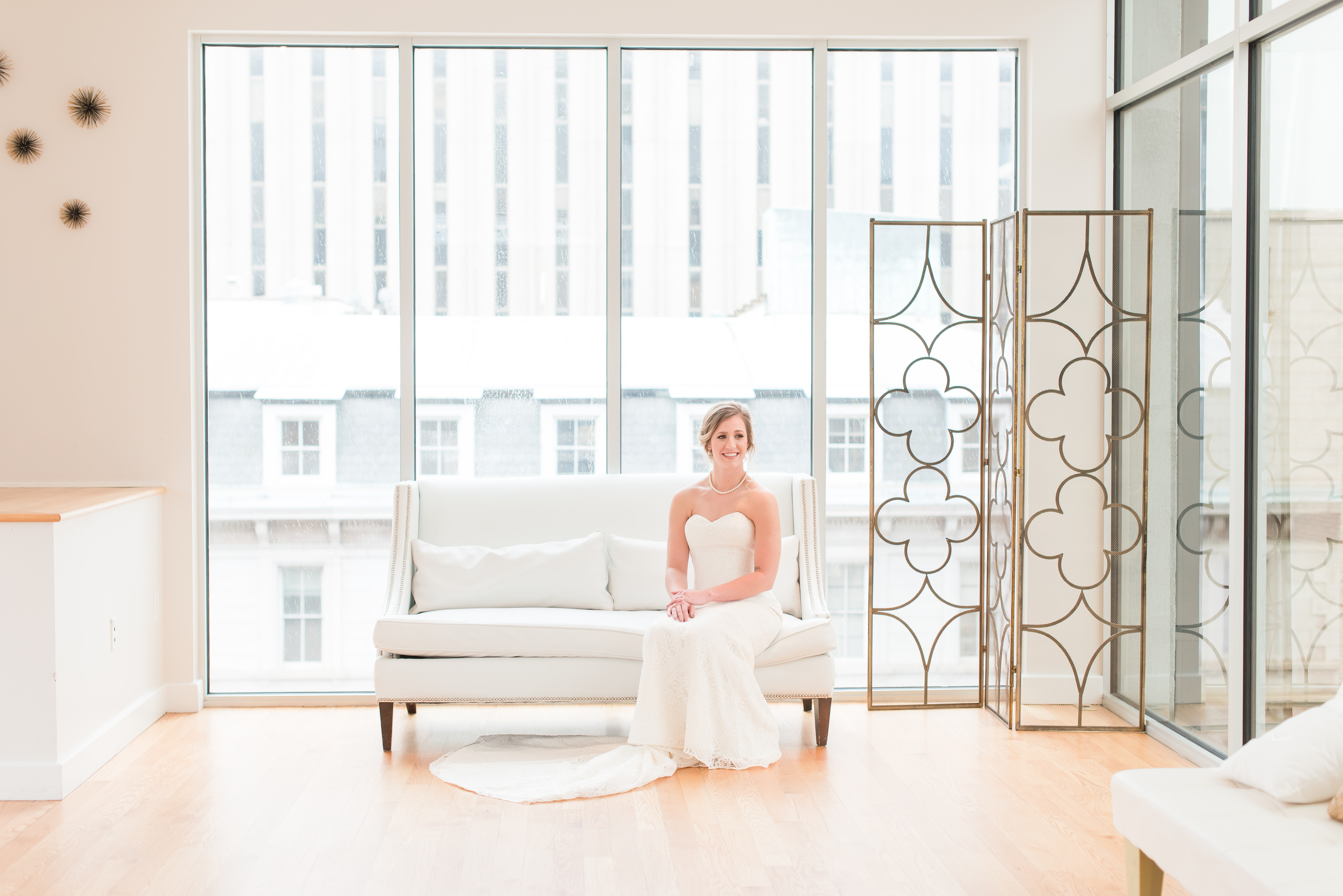 bride sitting on couch looking off at the Glass Box