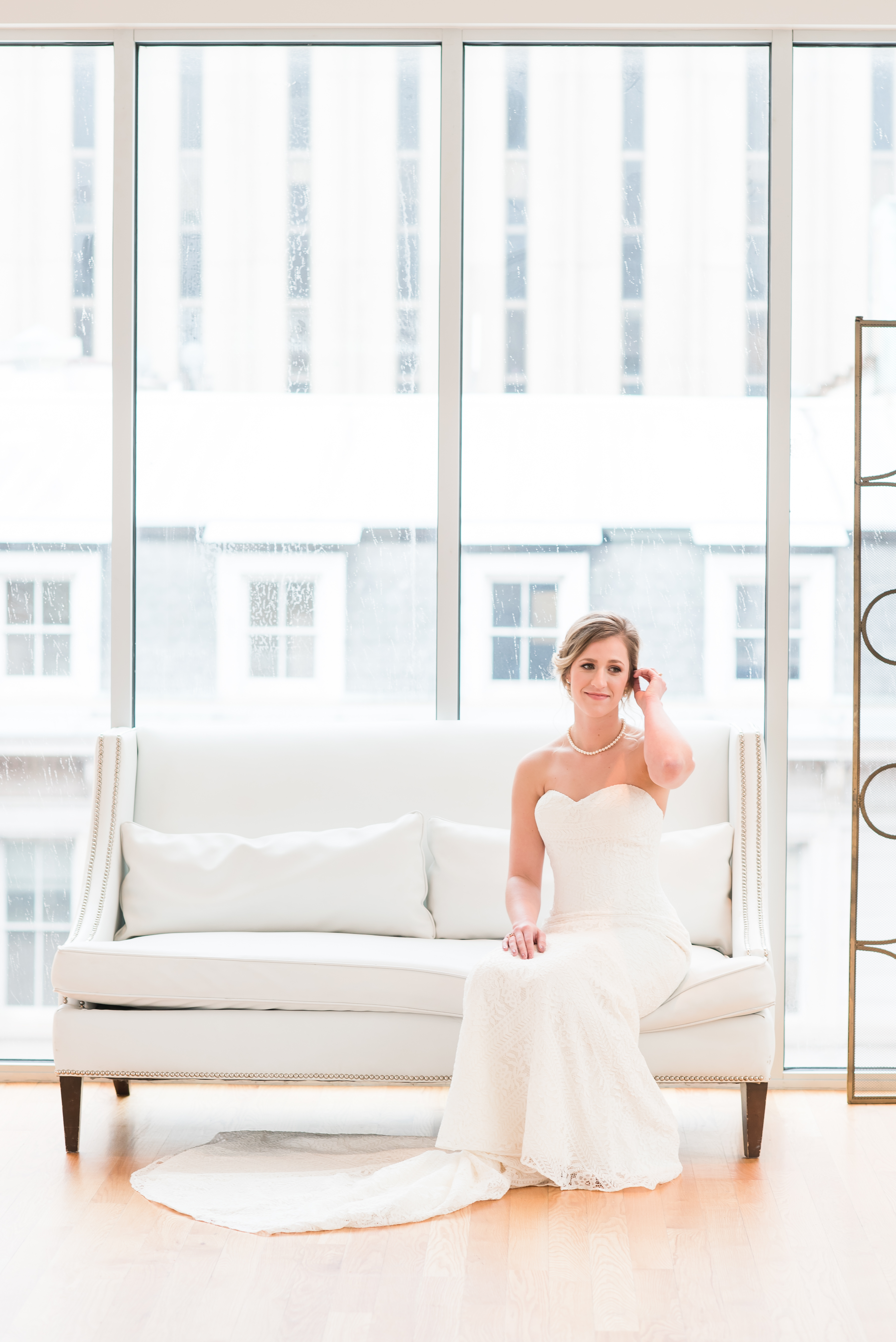 Bride sitting on couch at the Glass Box