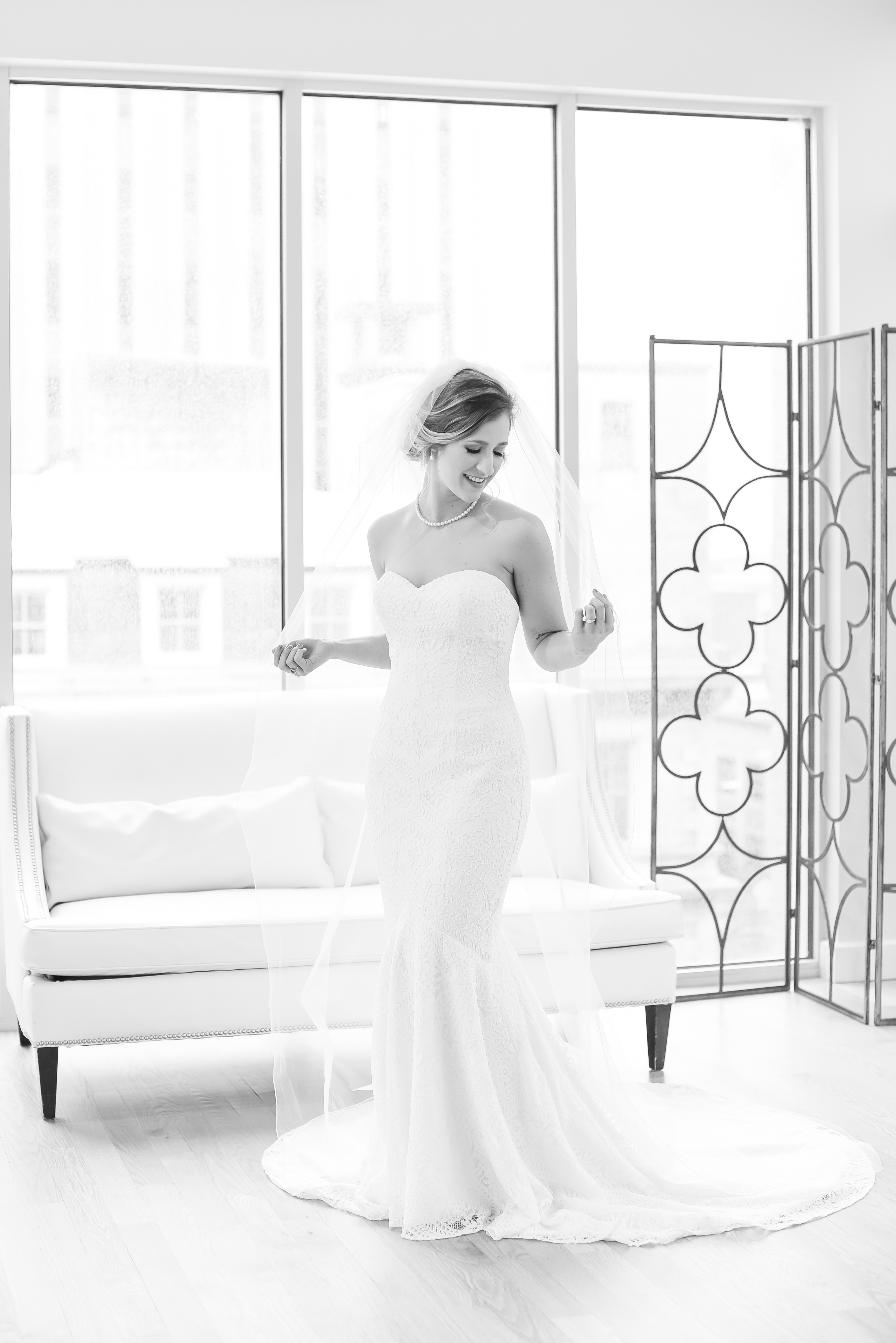 bride playing with cathedral length veil at the Glass Box