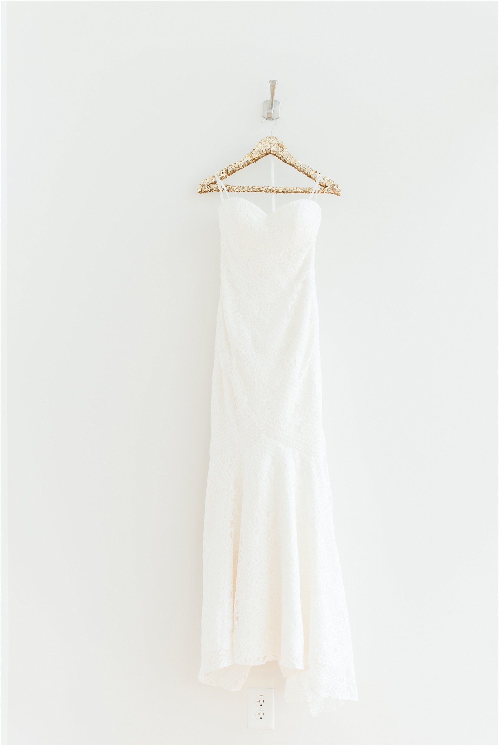 Wedding Dress on gold hanger at the glass box