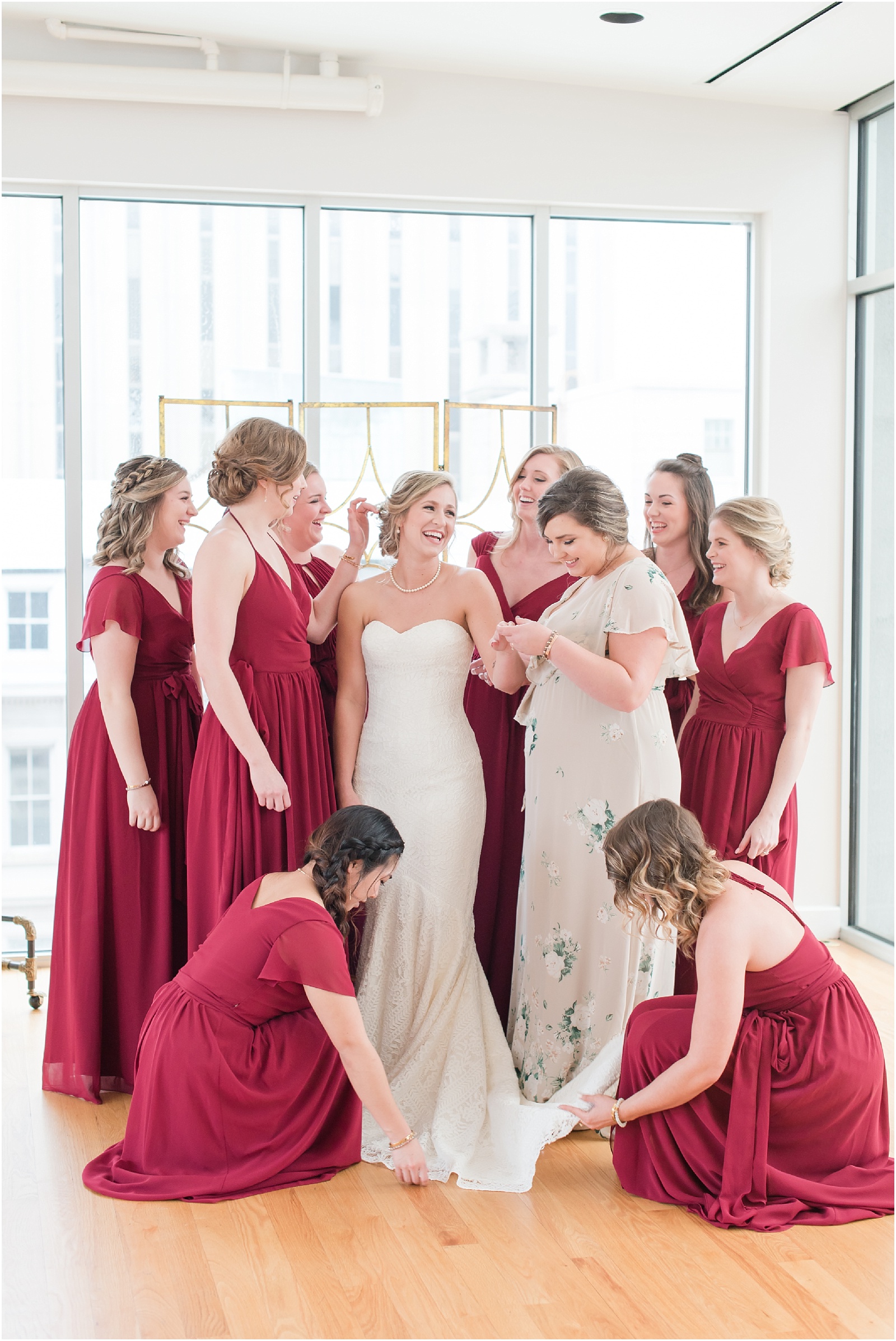 Bride with all her bridesmaids as she put on finishing touches at the glass box