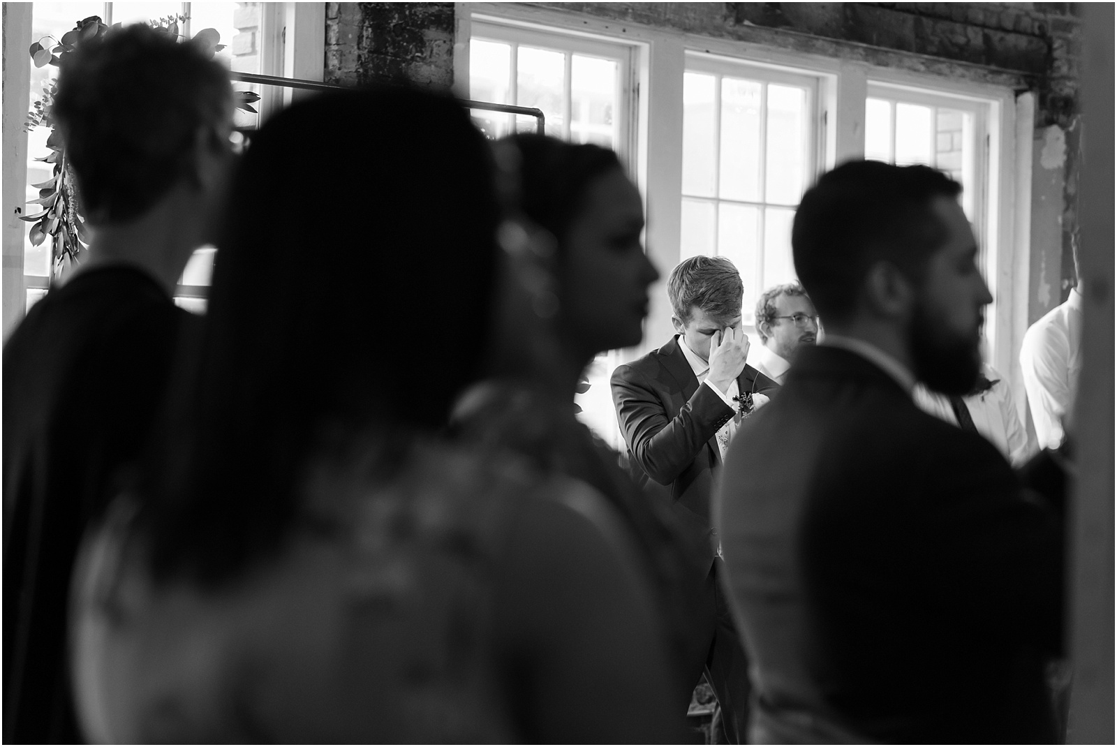 Groom's reaction to seeing his bride walking down the aisle for the first time at the glass box