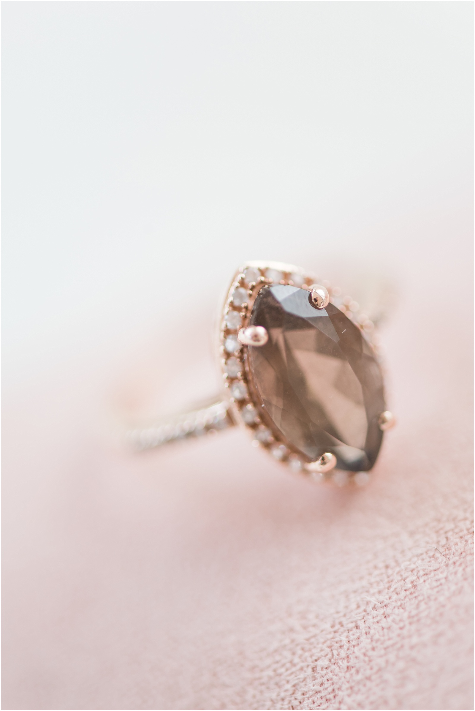 Antique engagement ring with a dark stone surrounded by diamonds at the glass box