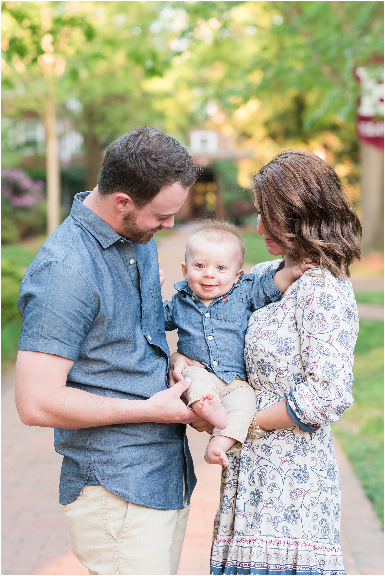a family photograph of a young couple with their baby at Elon College