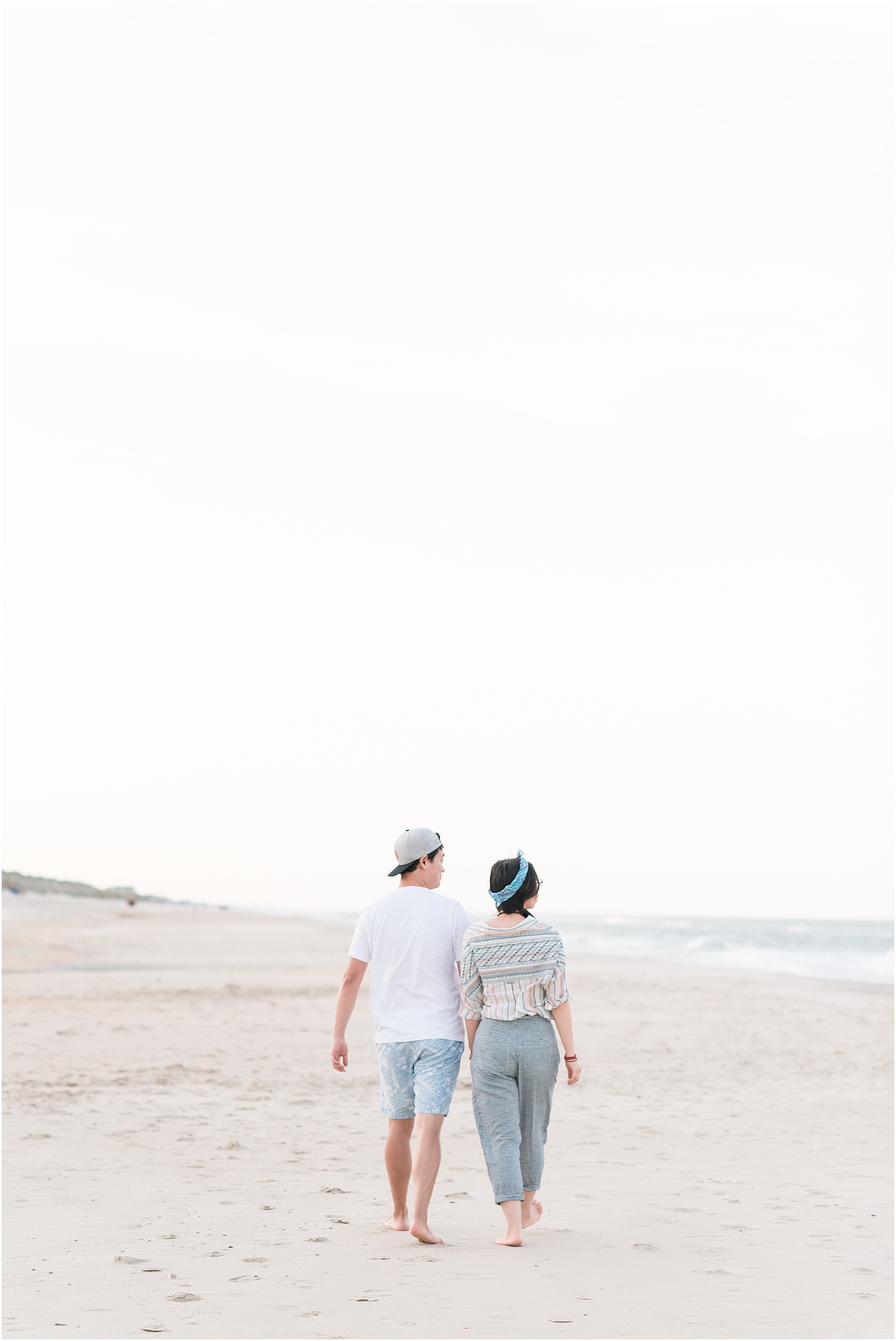 young couple walking on Corolla beach