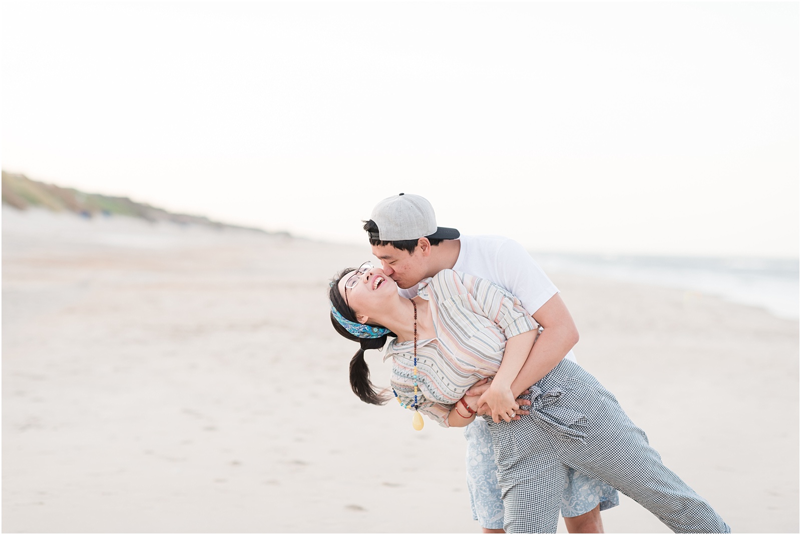 young couple laughing on corolla beach