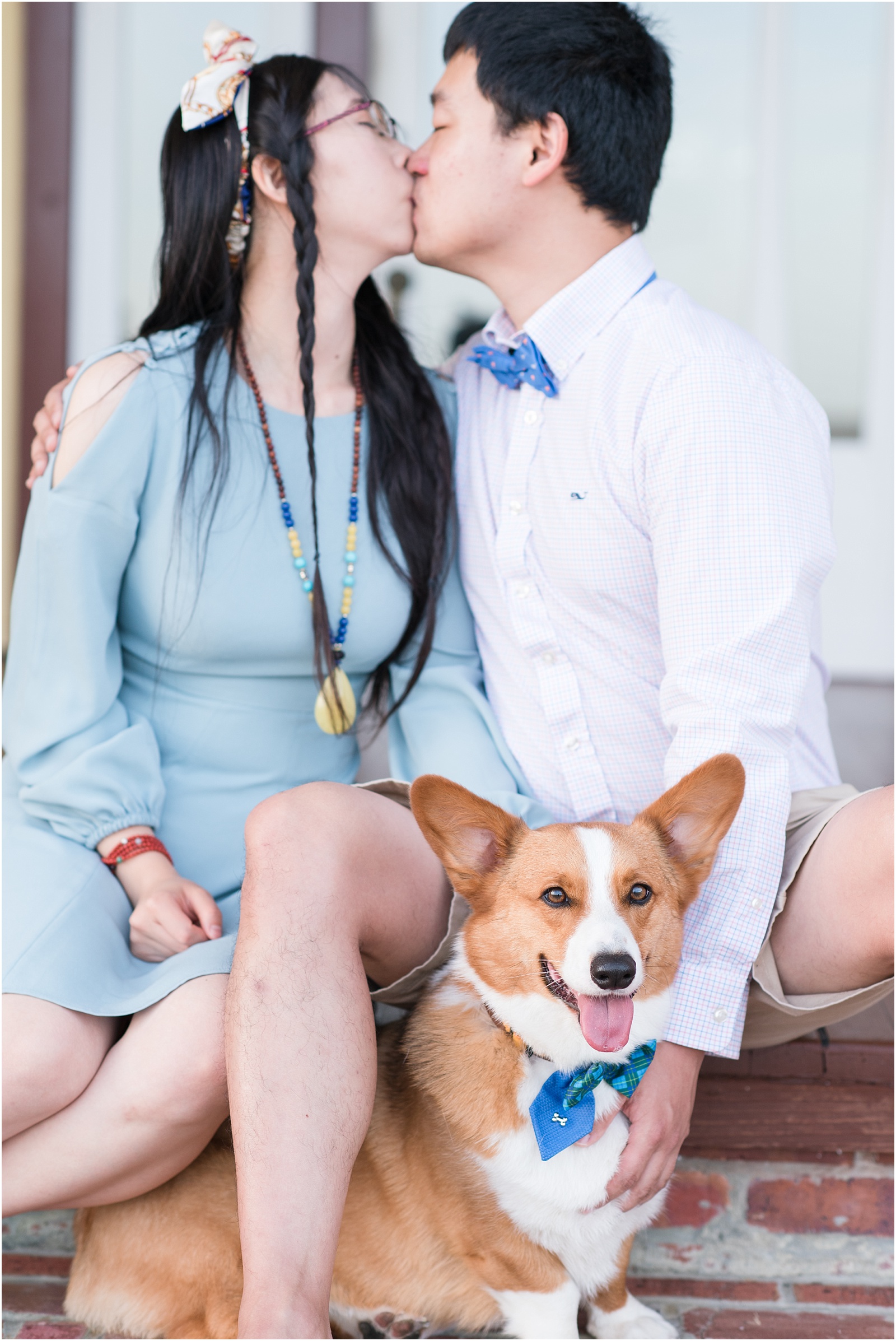 young couple kissing with corgi at Whalehead Club