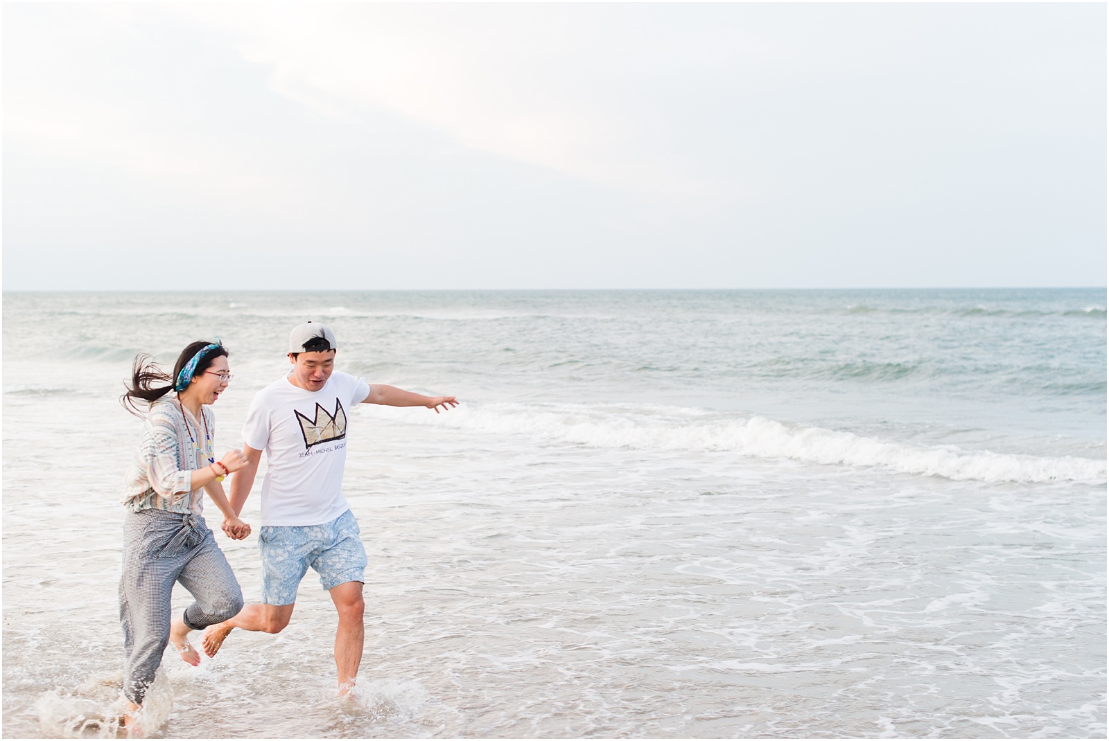 young couple running on corolla beach