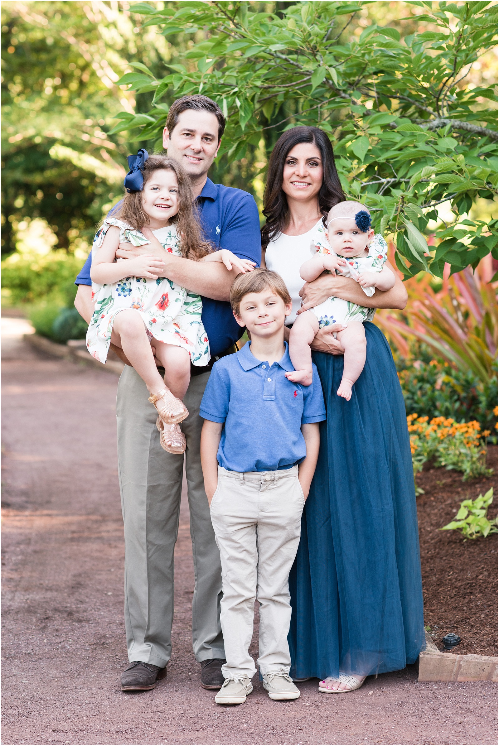 A family formal photograph with two kids and a baby at Duke Gardens