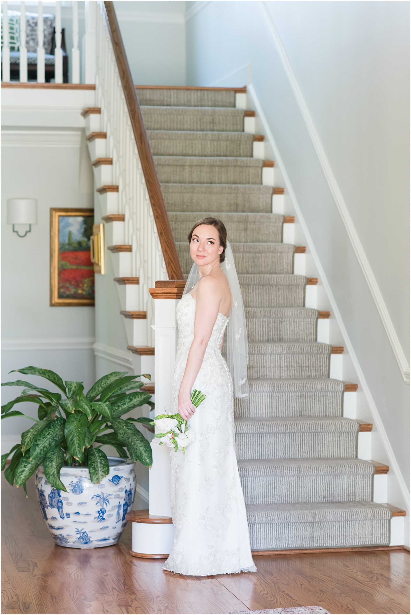 bride standing in front of staircase looking back at a Home Estate