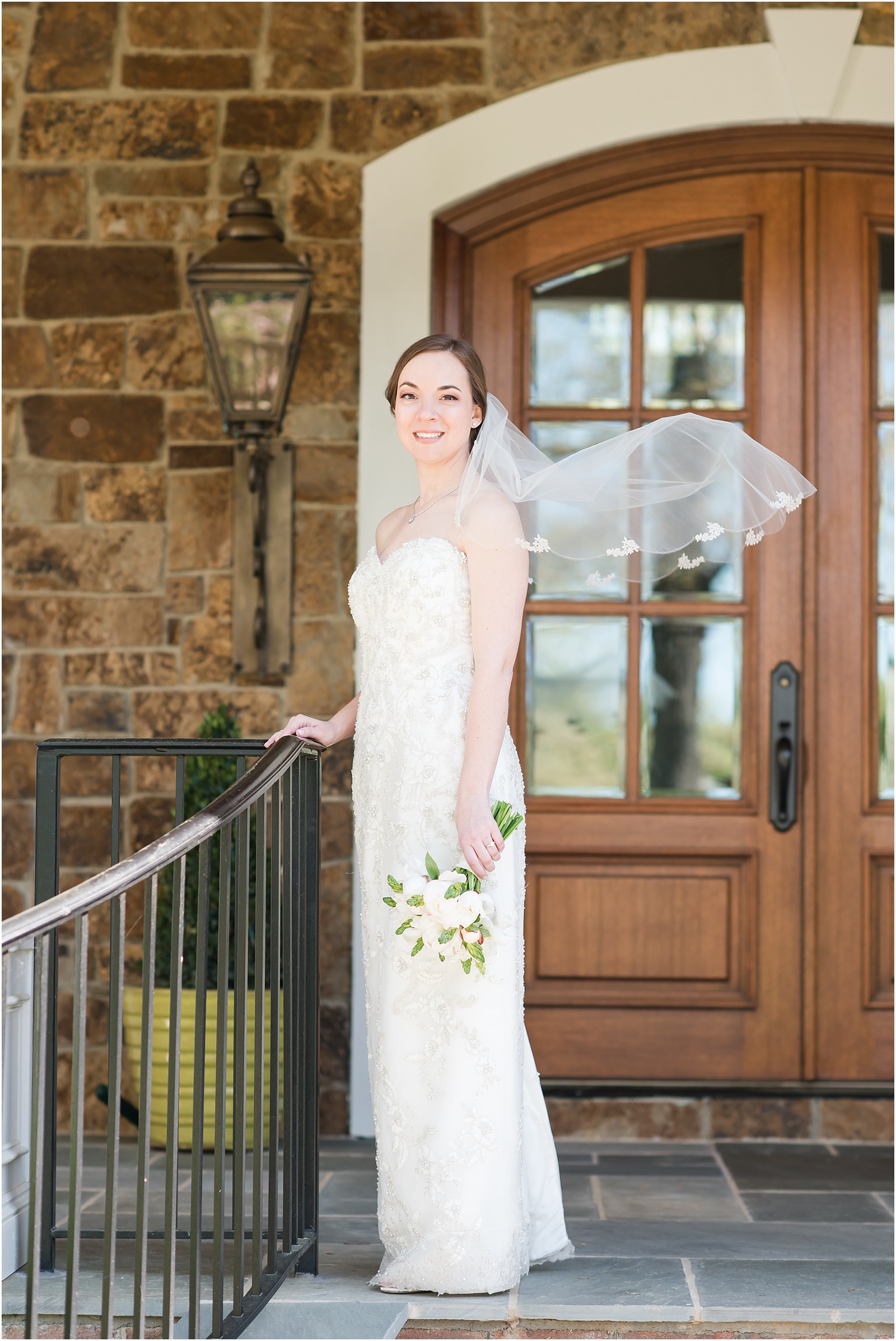 bride standing on front porch with veil at a bridal session at a Home Estate