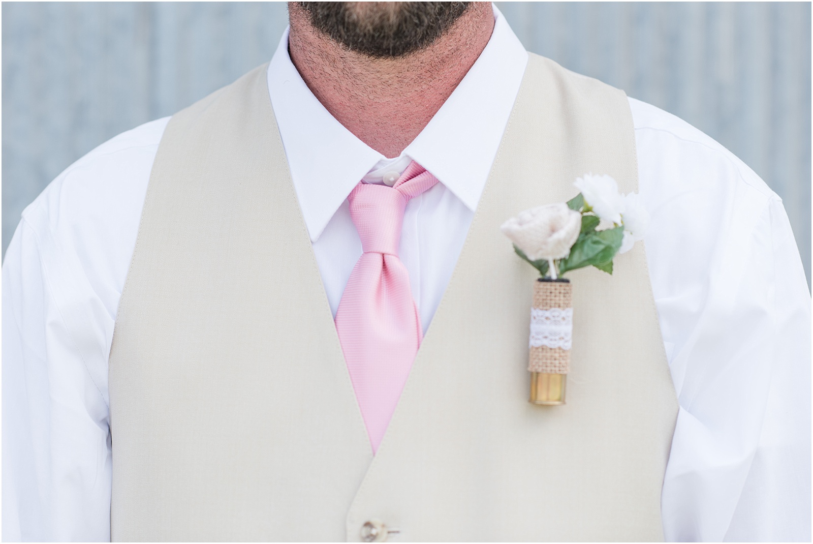 details of the groom with pink tie and tan vest at Starlight Meadow
