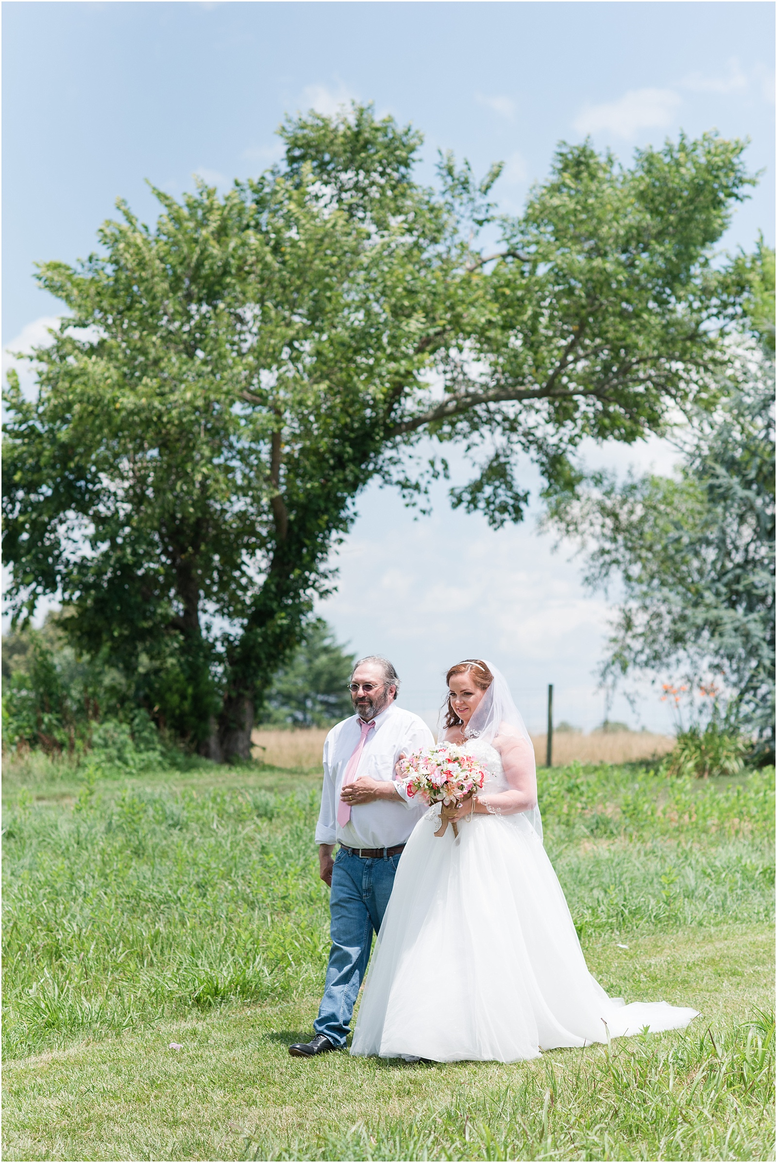 bride and father walking down the aslie at Starlight Meadow