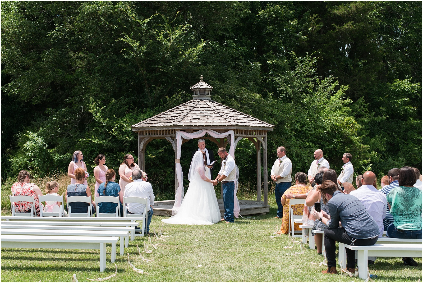 bride and groom at outdoor gazebo during ceremony at Starlight Meadow