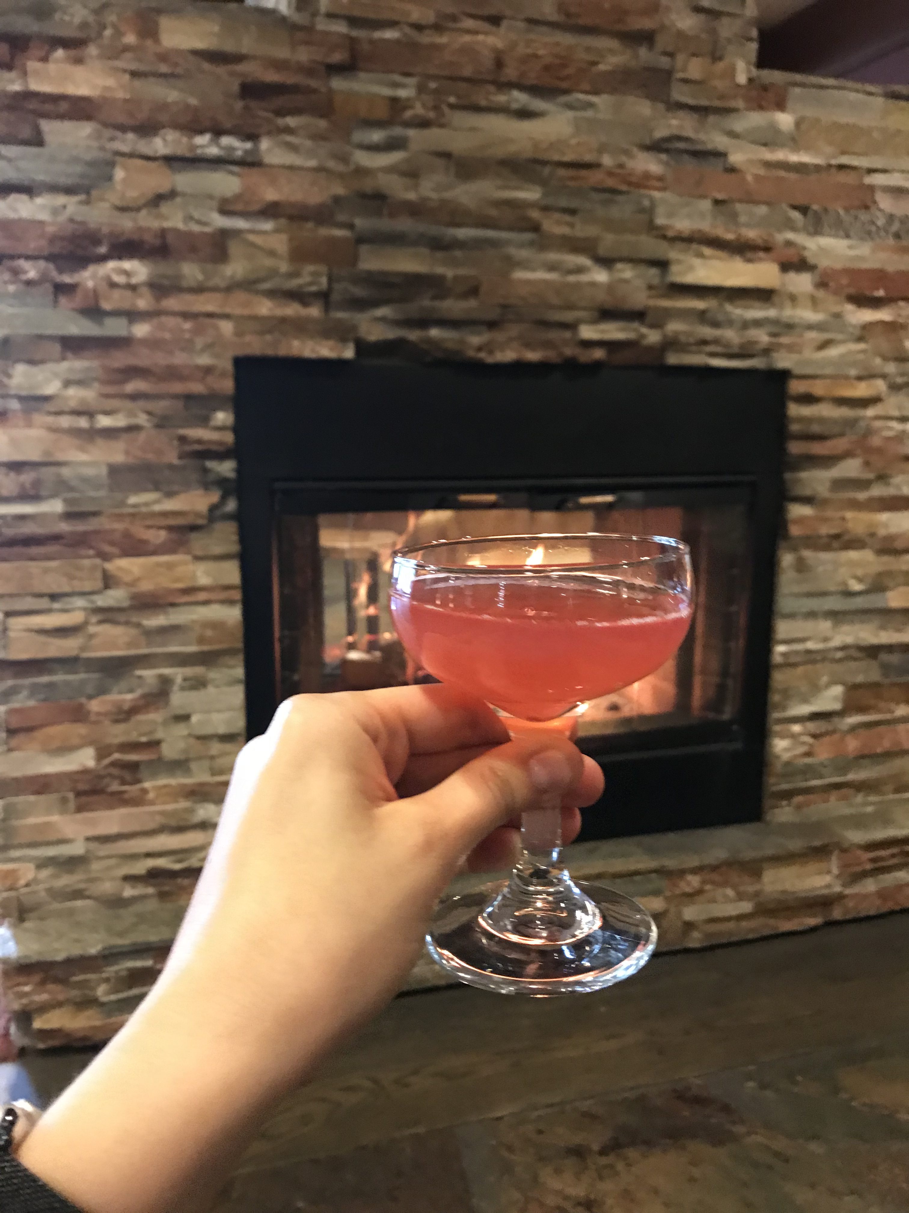 glass of rose in front of fire place at Salish Lodge