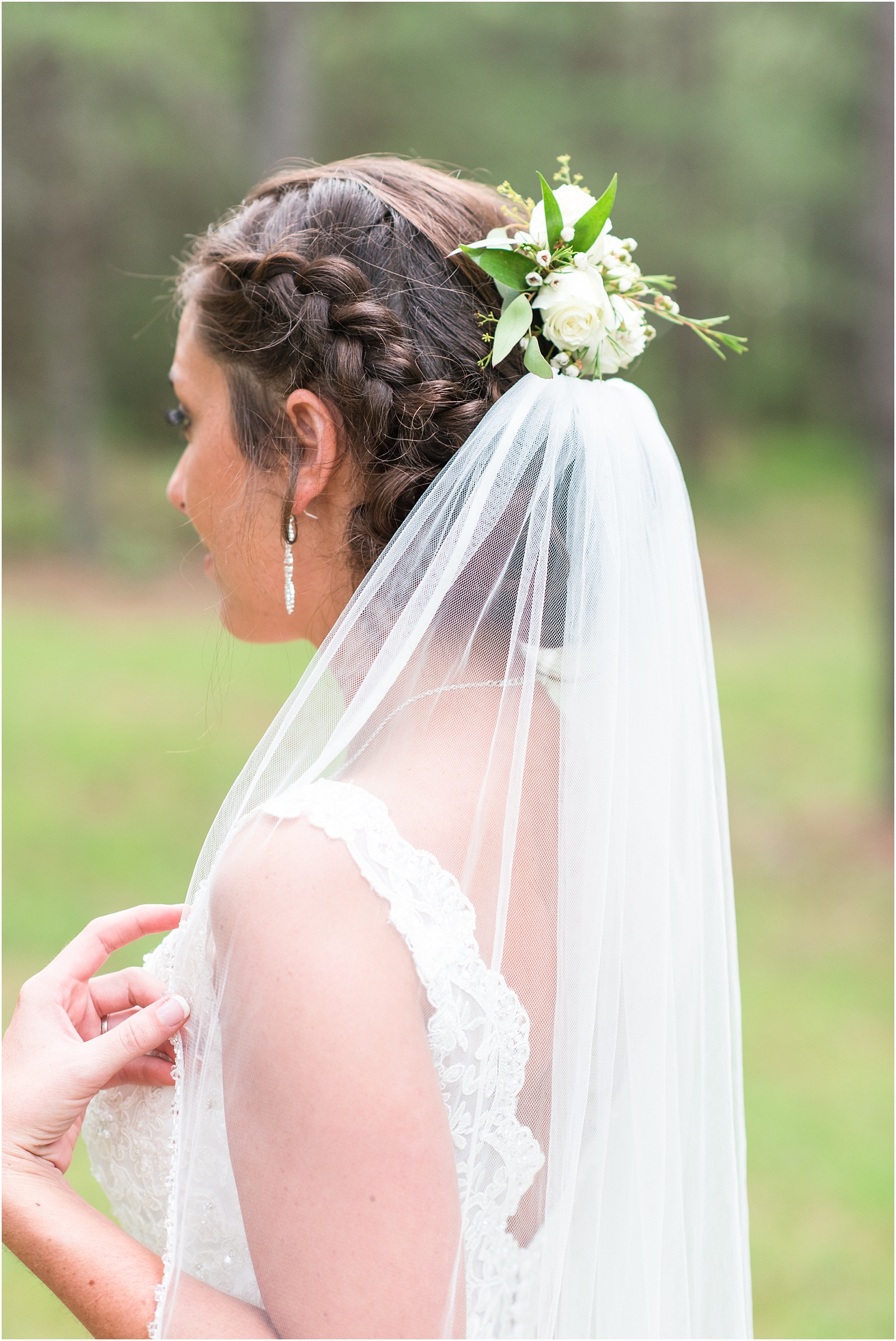 the back of the bride hair and veil details with white and green floral pin outside, Meadows At Walnut Cove, NC