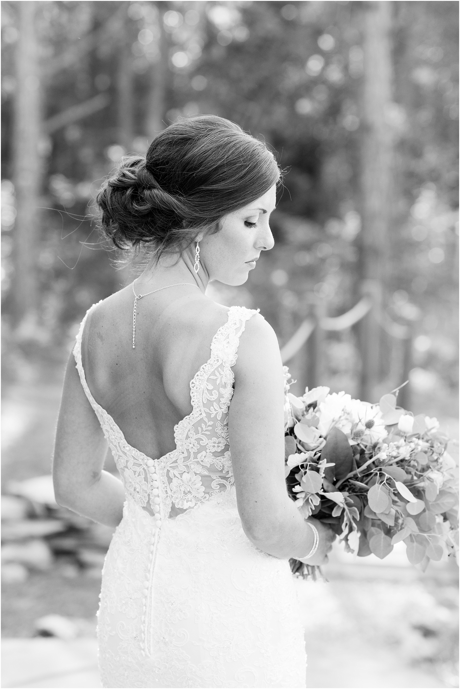 black and white of bride looking down at The Meadows At Walnut Cove
