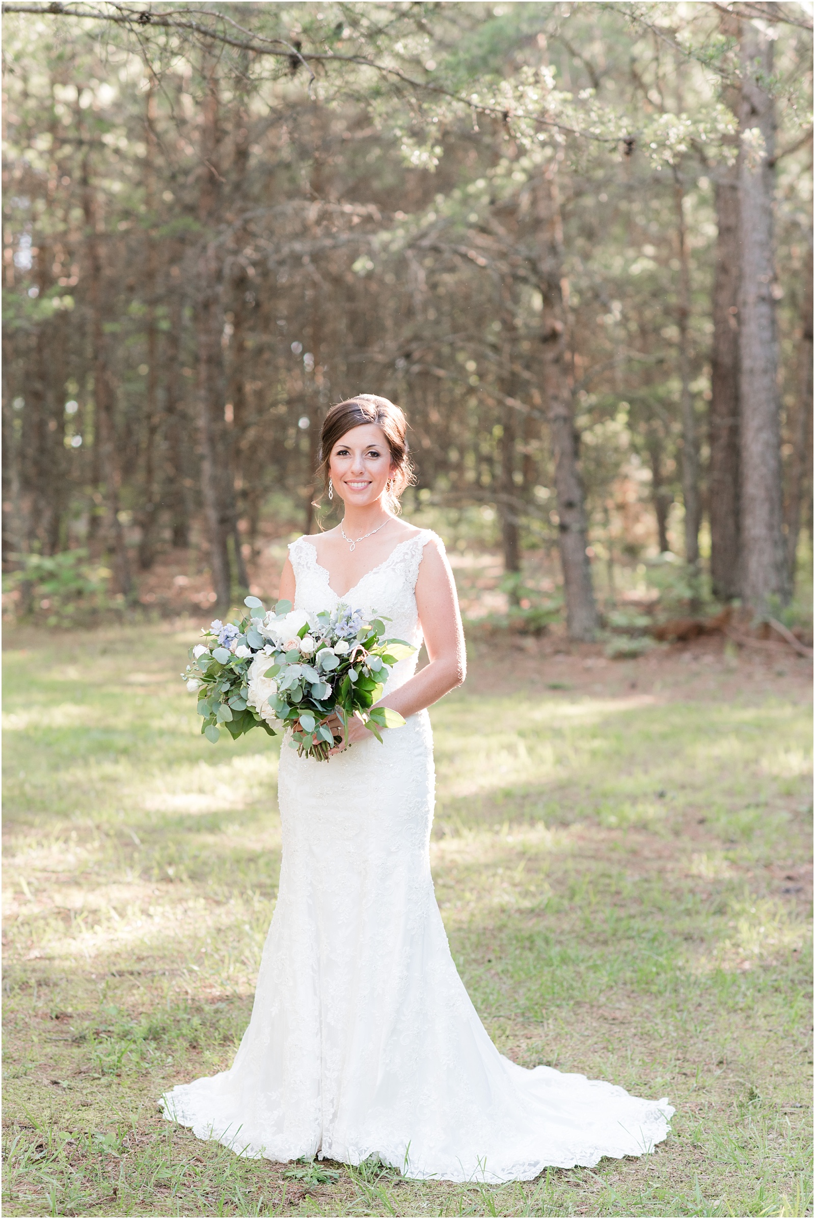 bride standing and holding lush bridal bouquet at The Meadows At Walnut Cove