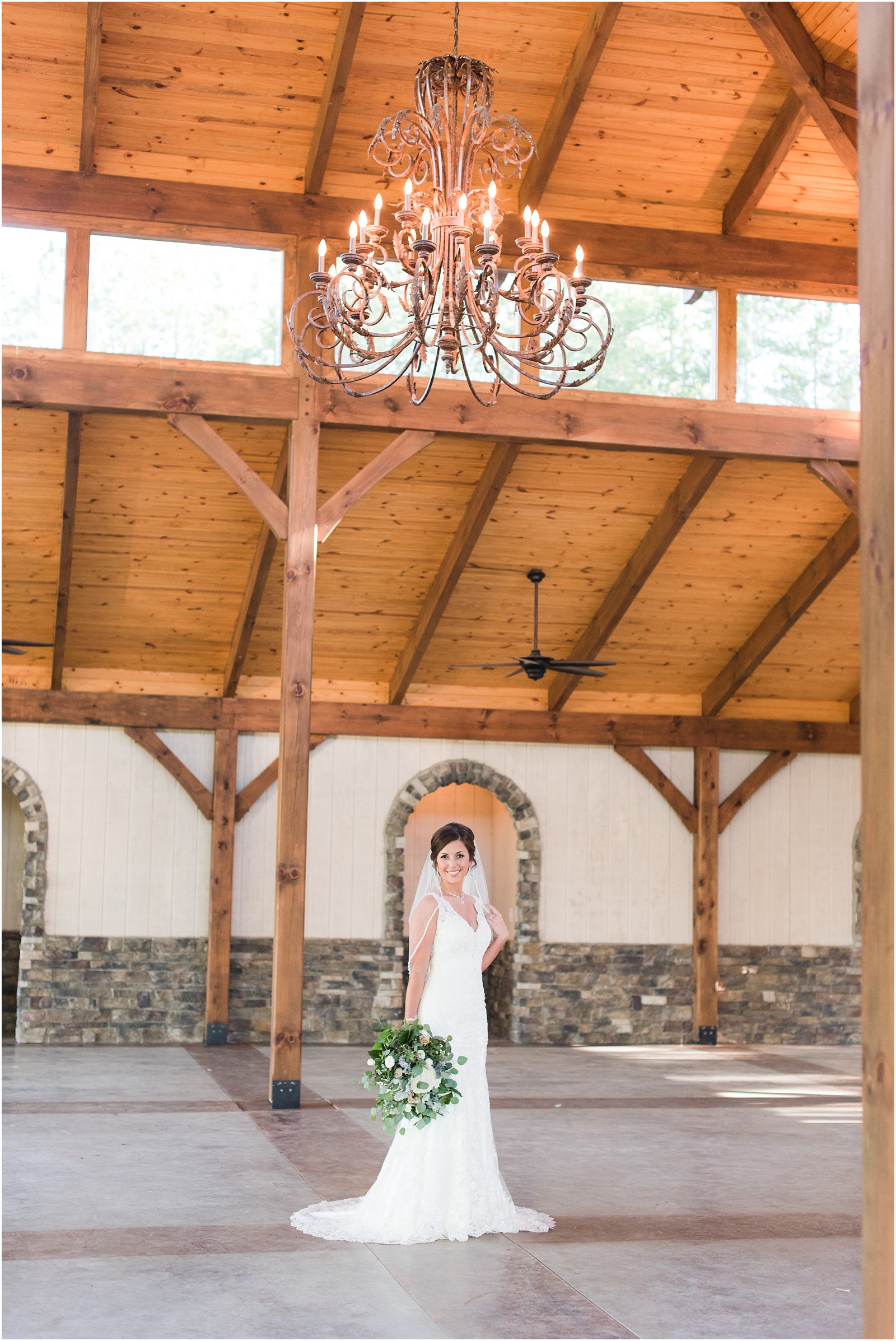 bride underneath big chandelier at The Meadows At Walnut Cove