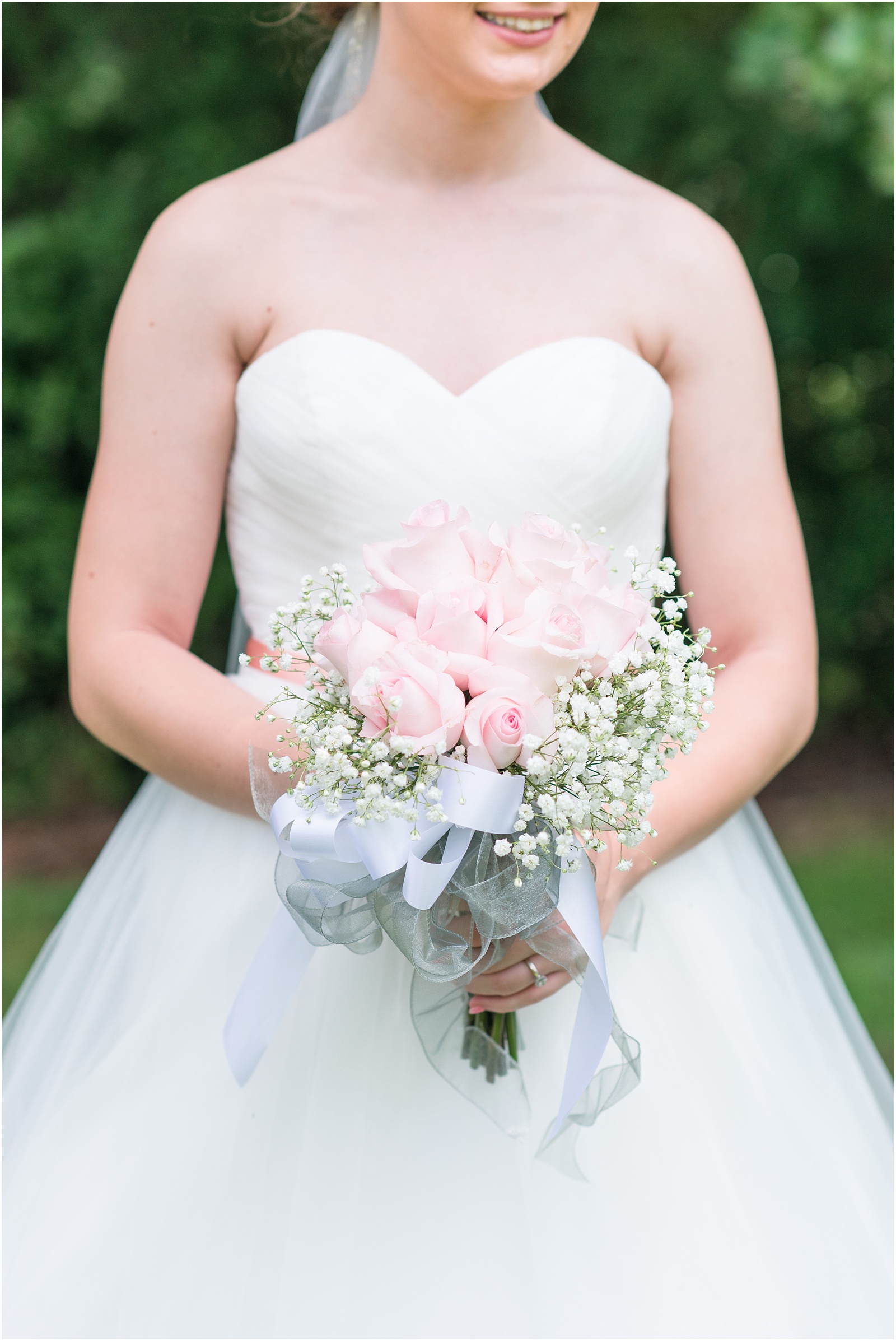 bride holding pink rose bouquet with babys breath mixed in at City Lake Baptist Church