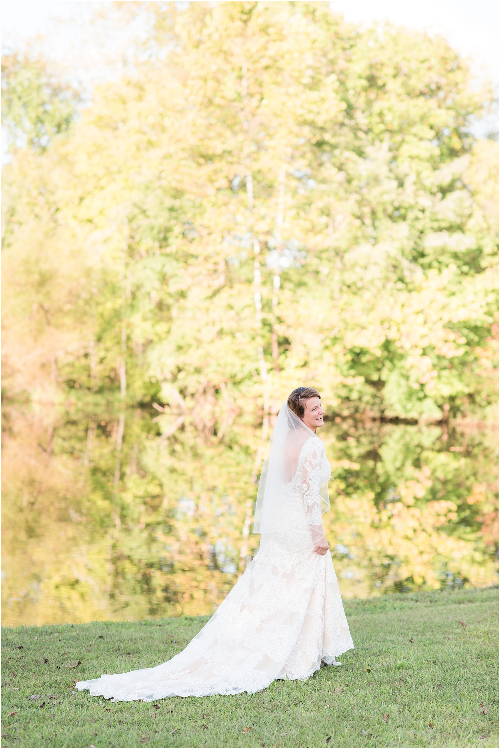 bride walking by a pond with fall leaves in the background with chamgne dress