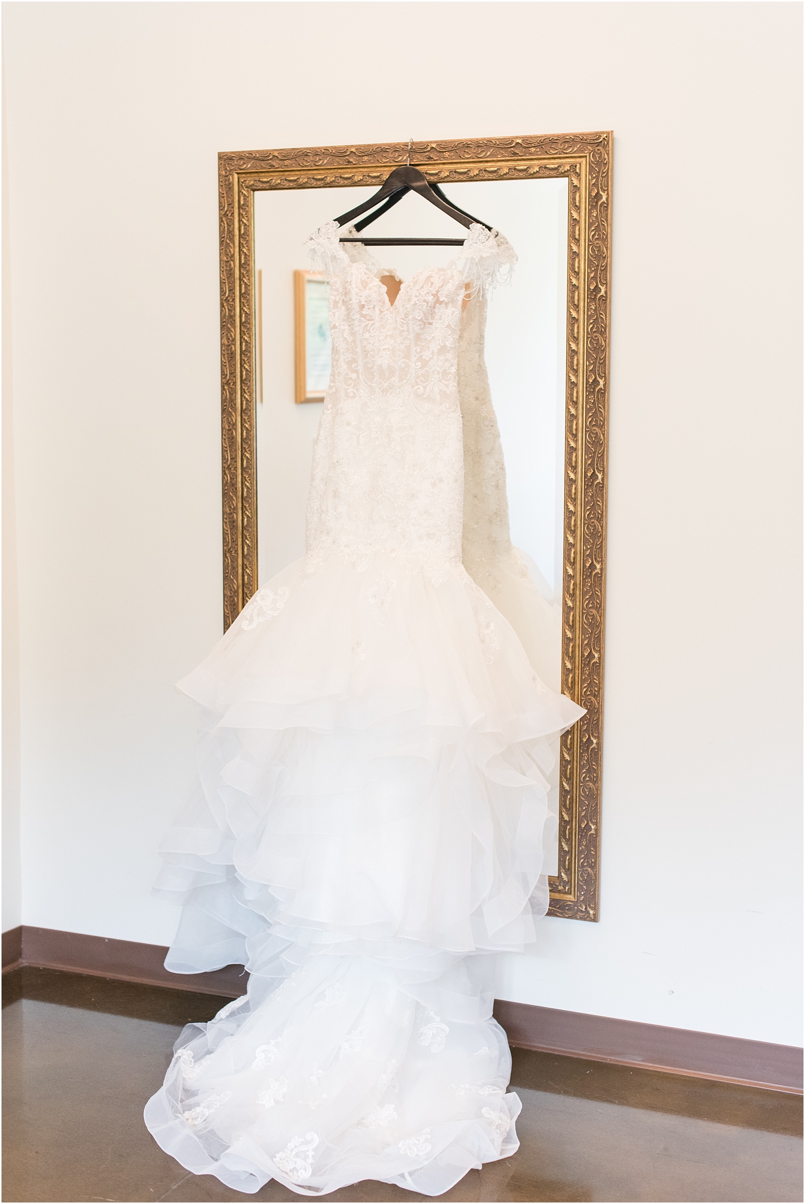wedding dress on top of large mirror