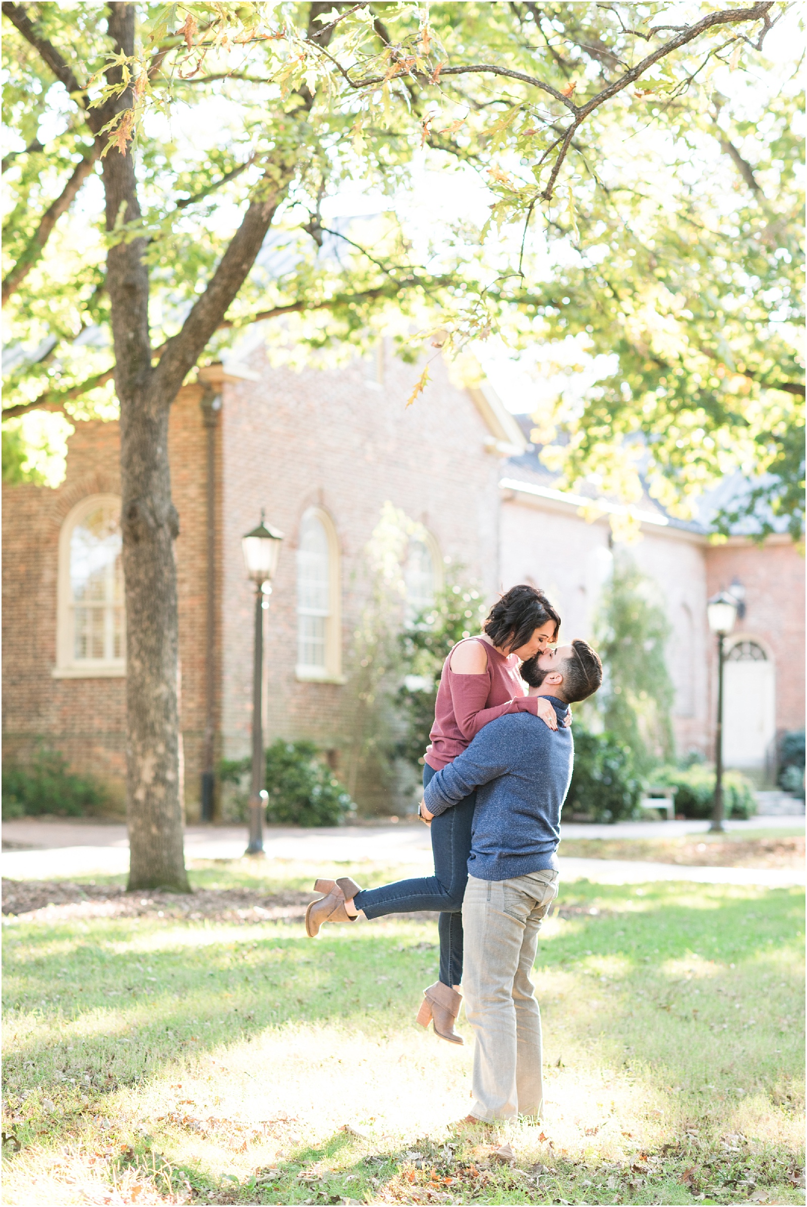 a groom lifting up his bride and kissing her on UNC Chapel Hill's college campus 
